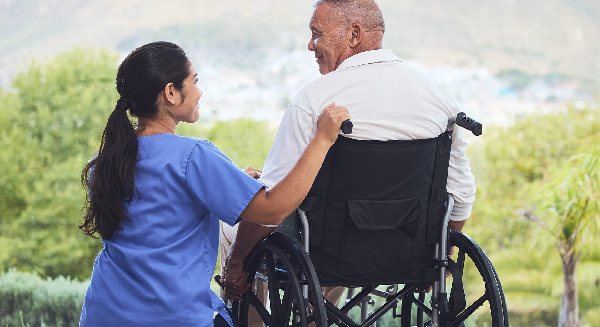 Accessible Home Environment: Healthcare worker and man in wheelchair.